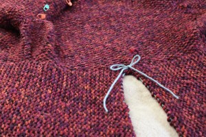 Joining waste yarn to hold at the top of the cut